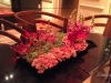 Low tin trays lush with succulents, snapdragons, Rothchild lilies and more for the sitting tables