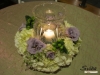 Cocktail tables embellished with delicate wreaths of hydrangeas, roses and lisianthus with hurricane in center